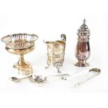 A pierced pedestal bonbon dish raised on spreading circular foot, a sugar sifter, a cream jug,