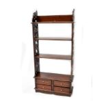 Reproduction mahogany wall shelves with pierced fret end, three shelves over four short drawers,