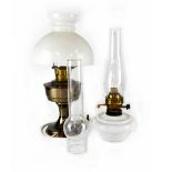 An opaque glass oil lamp with funnel and one other with metal base and opaque glass shade,