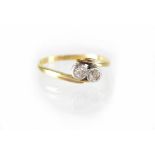 An 18ct gold and platinum ring set with two small diamonds, size N, approx 1.8g.
