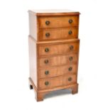 A reproduction bow-front six-drawer chest to plinth support, 84 x 42cm.
