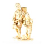 A late 19th century Japanese carved ivory okimono figure group depicting a man with basket holding