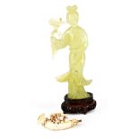 A modern green jade figure of a geisha on pierced wood stand,