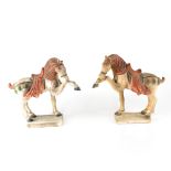 A pair of Tang Dynasty style horses on square plinth base, length approx 31cm, height approx 27cm.