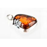 A white metal pendant set with amber-coloured stone.