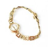 A ladies' vintage Rotary wristwatch on a 9ct gold textured and pierced strap, approx 11.5g.