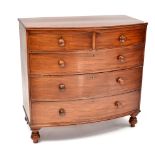 A Victorian mahogany bow-fronted chest of two short over three long drawers, raised on turned feet,