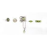 Five items of jewellery set with peridots comprising four rings and a pendant with one other