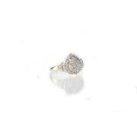 A 9ct white gold ring in the form of a heart set with baguette and brilliant cut diamonds,