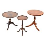 A small reproduction mahogany occasional table with piecrust rim raised on turned supports to three