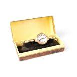 A ladies' vintage 9ct gold watch, the silvered circular dial set with numbered time markers,