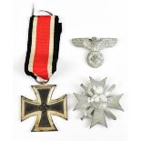 A German WWII Third Reich Iron Cross First Class with ribbon, a further Third Reich badge and a