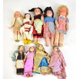 A group of dolls comprising a small Armand Marseille example and further souvenir dolls.