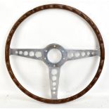 JAGUAR; a wooden rimmed E Type S1/S2 16" steering wheel with three central alloy spokes.Additional