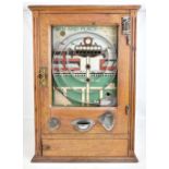 An early 20th century 'Win and Place' penny-in-the-slot machine, oak cased with coloured detail to