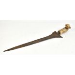 A Javanese kris with possibly 17th century carved bone handle and simple sheath, length 50cm.