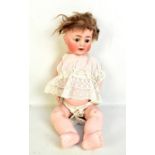 An early 20th century German bisque headed doll with brown wig (cut), open/closed blue eyes, open