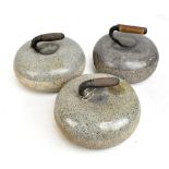 Three curling stones, unmarked, with metal and wooden handles, diameter of each approx 23cm (3).