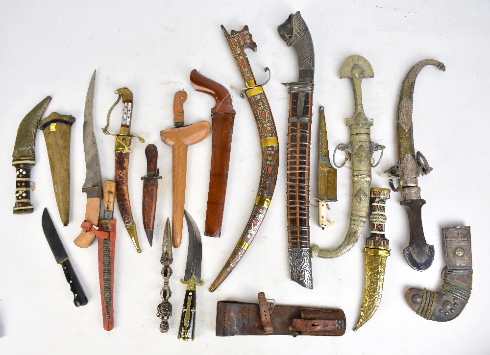 A mixed group of Middle Eastern daggers including pesh-kabz, kris, Sudanese dagger with curved blade