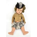 A mid-20th century Shirley Temple composition doll with curly blonde wig and period outfit,