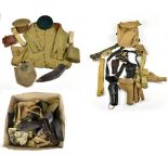 A group of uniforms and equipment including an officer's cap, a felted flask (af), canvas gun