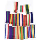 A large collection of medal ribbons, approximately nineteen different variations and various