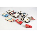 Eight mid-20th century Japanese tinplate toys comprising two police cars and buggy, length of larger