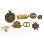 A group of military related badges and buttons including an East Lancashire Regiment cap badge, a