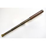 BROADHURST CLARKSON & CO LTD; a three draw leather and brass telescope, length when extended 75cm.