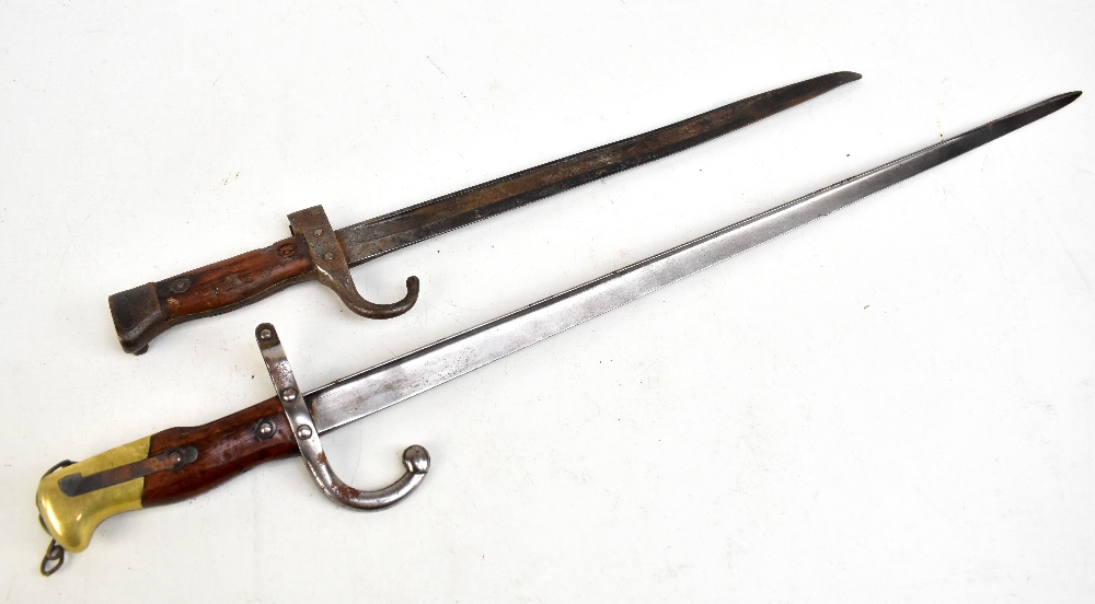 A late 19th century French bayonet with rubbed signature and date of 1876 to the blade back, the