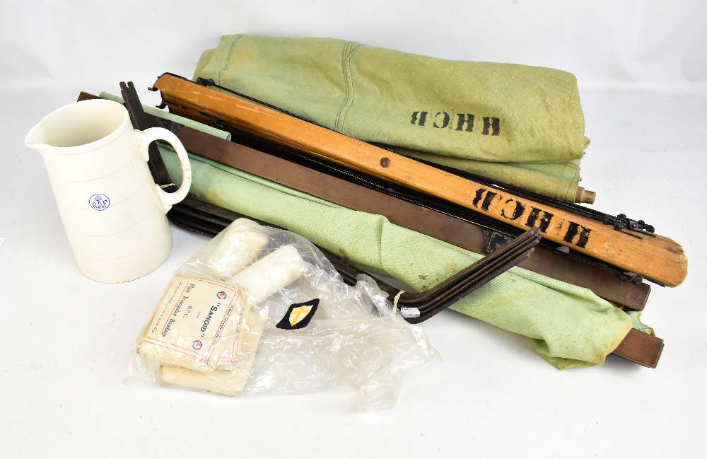 Two WWII period camp beds, a group of contemporary bandages and a Minton RAF jug.