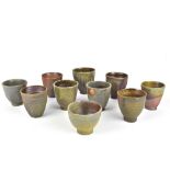 CLAYTON AMEMIYA; a group of ten wood fired stoneware cups, incised CA marks, tallest 10cm (10).