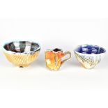 CHRIS BASKIN; two cut sided fluted soda fired porcelain bowls and a small jug, impressed CB marks,