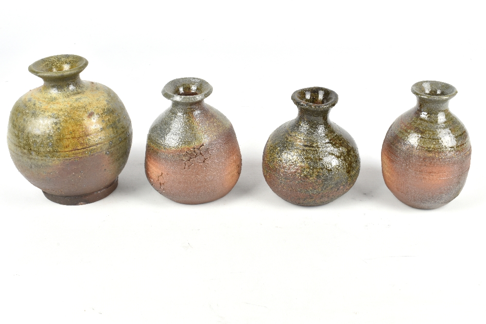CLAYTON AMEMIYA; a group of four small wood fired stoneware bottles, incised CA marks, tallest