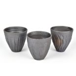 CLAYTON AMEMIYA; a group of three wood fired stoneware cups, incised CA marks, tallest 10.5cm (3).