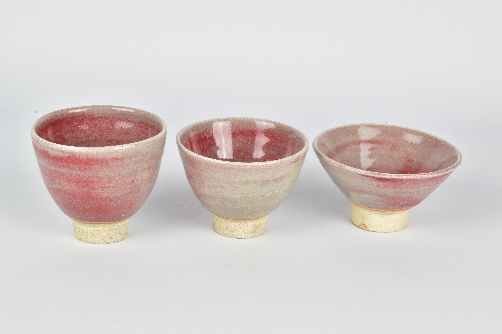 CLAYTON AMEMIYA; a group of three stoneware sake cups washed in copper red glaze, incised CA - Image 3 of 6