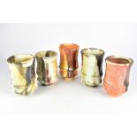 JASON HESS; a group of five wood fired porcelain tumblers, impressed JH marks, tallest 14cm (5).