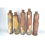 JARED GABRIEL; an installation of five wood fired stoneware bottles with incised linear