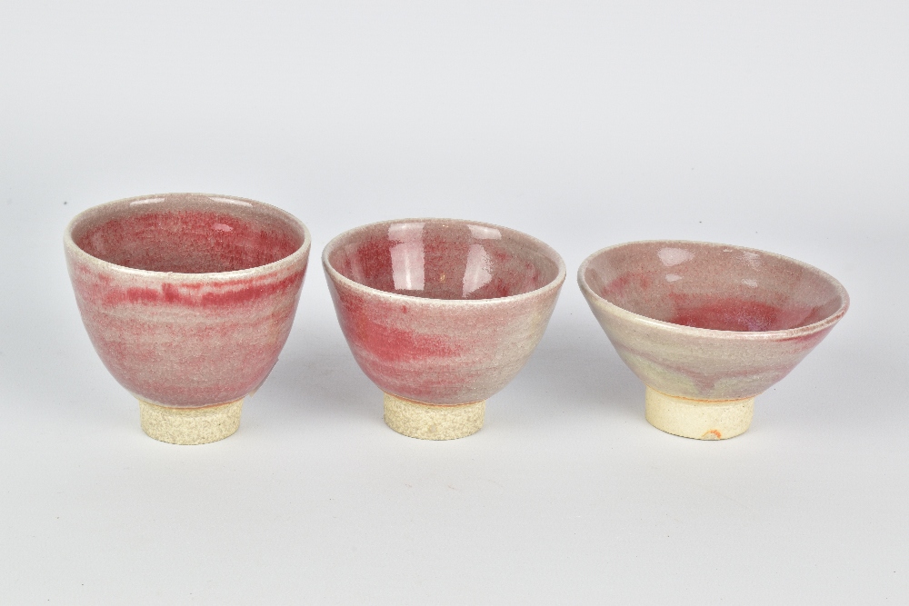 CLAYTON AMEMIYA; a group of three stoneware sake cups washed in copper red glaze, incised CA - Image 2 of 6