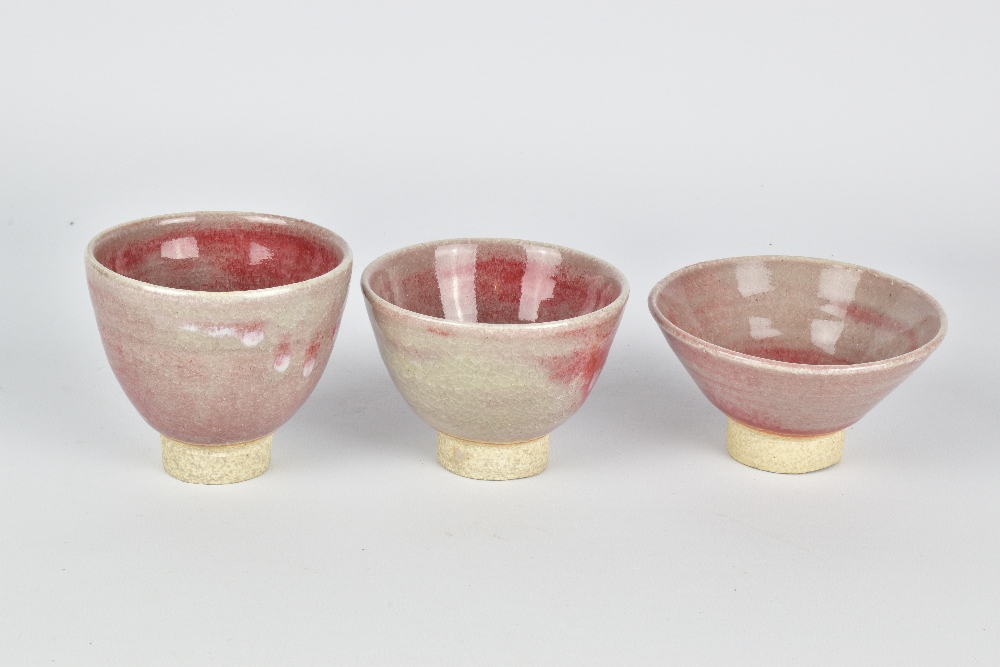 CLAYTON AMEMIYA; a group of three stoneware sake cups washed in copper red glaze, incised CA - Image 4 of 6