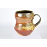 HEIDI BLETT; a wood fired stoneware mug, incised signature, height 12.5cm. Provenance: Purchased
