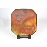GARY HOLT; a square stoneware footed platter with angled corners covered in an iridescent glaze,