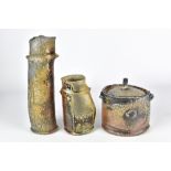 BARB CAMPBELL; a lugged wood fired stoneware jar and cover and two lugged vases, incised signatures,