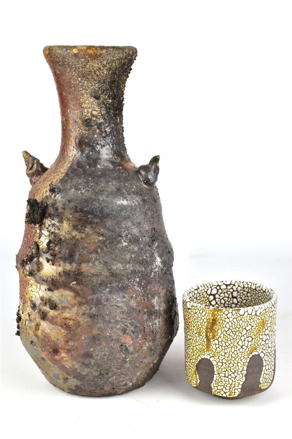 BRENDAN FULLER; a lugged wood fired stoneware bottle with heavily textured surface and a cup,