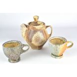 SAM CHUMLEY; a wood fired stoneware teapot and matching pair of cups, impressed S mark to teapot,