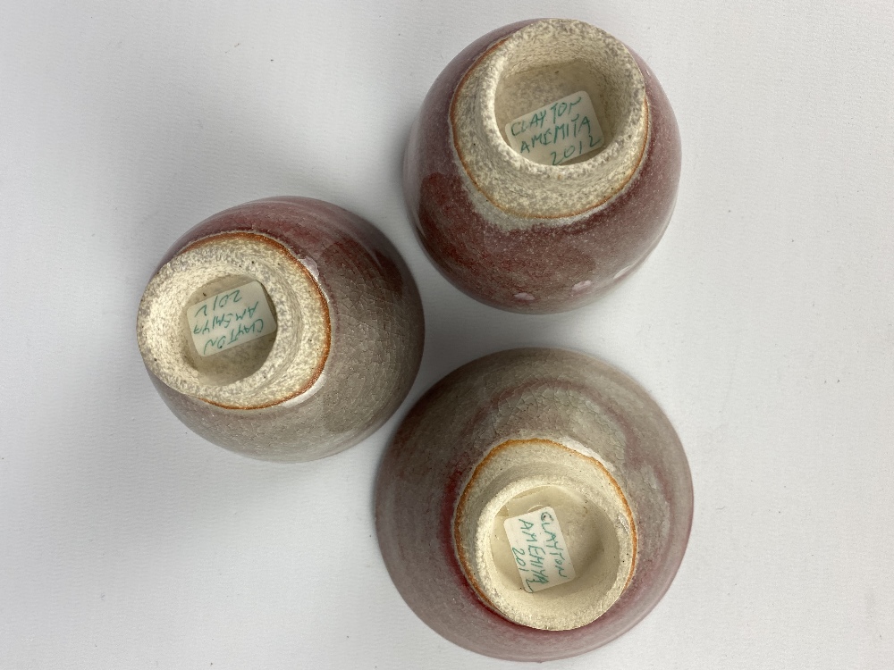 CLAYTON AMEMIYA; a group of three stoneware sake cups washed in copper red glaze, incised CA - Image 6 of 6