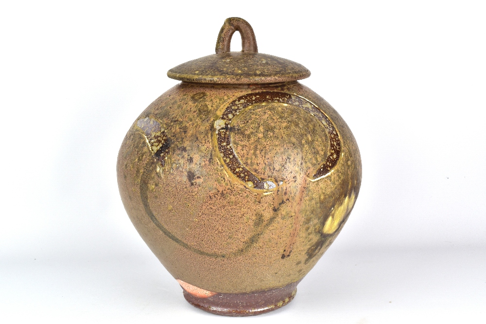 WALLY BIVINS; a large wood fired stoneware jar and cover with carved decorative sweeps, incised