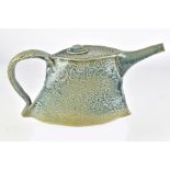 JACKSON GRAY; a stoneware teapot with floral decoration covered in blue/grey glaze, incised