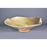 CHRIS GUSTIN (born 1969); a large altered wood fired porcelain bowl covered in shino glaze,