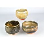 PAUL DRESANG (born 1948); a group of three wood fired stoneware teabowls, impressed PAD marks,